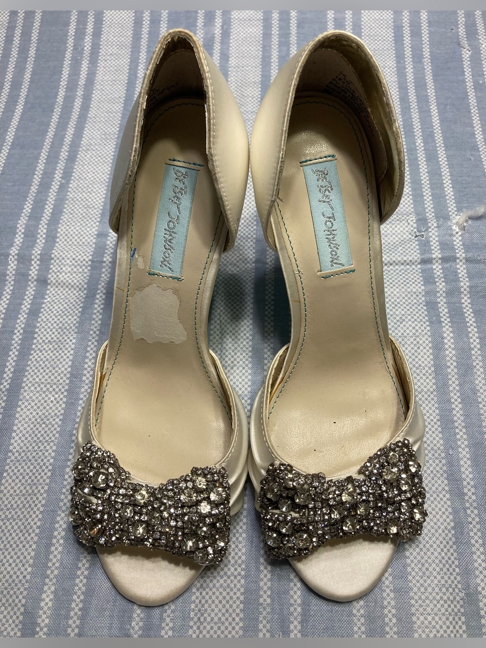 Betsey Johnson “Gown” ivory heels with silver rhinestone bow deign.